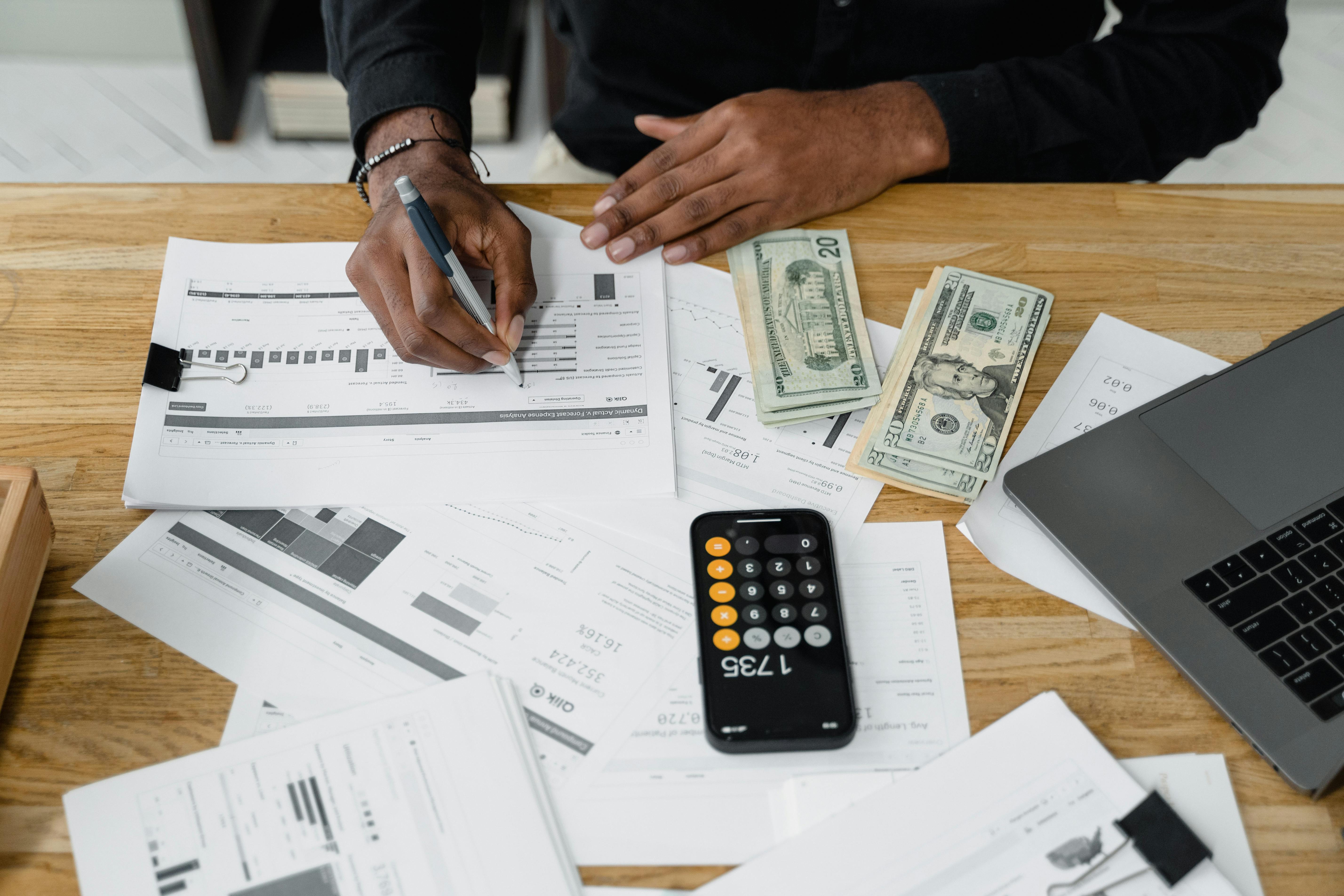 Accounting workspace with calculator and paperwork for invoice planning